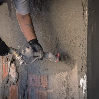 Construction,Worker,Applying,Cement,Plaster,On,The,Wall,Surface,With